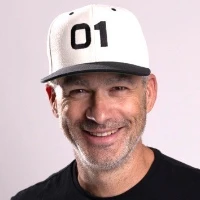 Kyle Duford, founder and editor of BRNDWIRE, smiling in a white baseball cap with the number 01